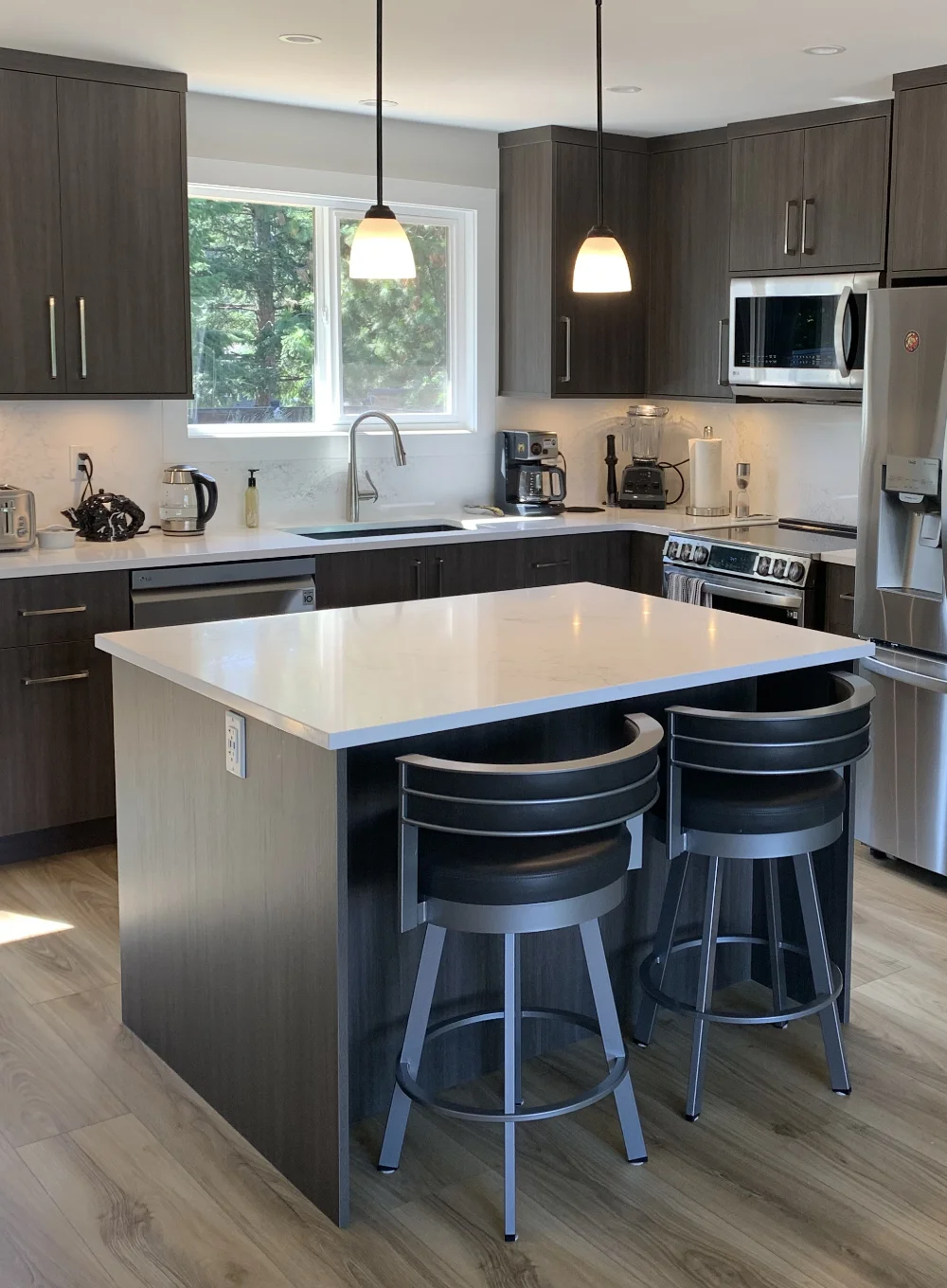 Custom kitchen with soft lighting and dark brown cabinets