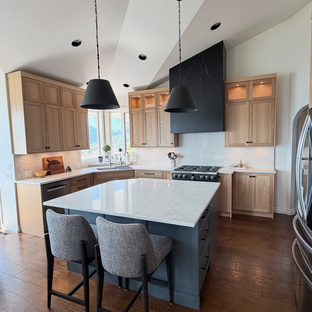 Kelowna kitchen range wall seen across the island after the renovation by Amend Developments
