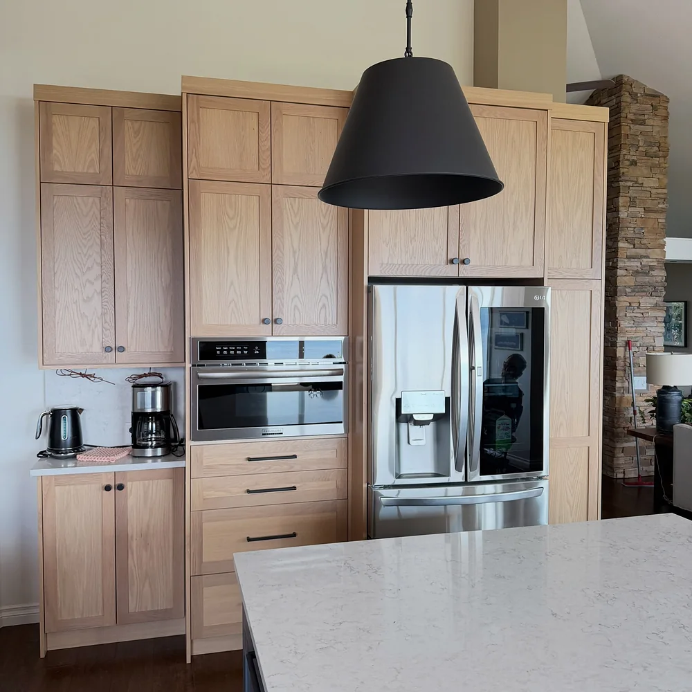 Kelowna kitchen refrigerator wall after the renovation by Amend Developments