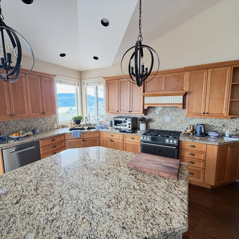 Kelowna kitchen range wall seen across the island before the renovation